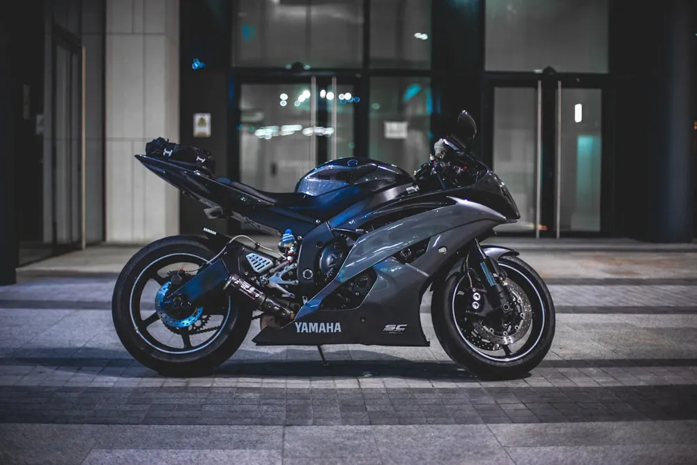 Black Yamaha sportbike in front of a building